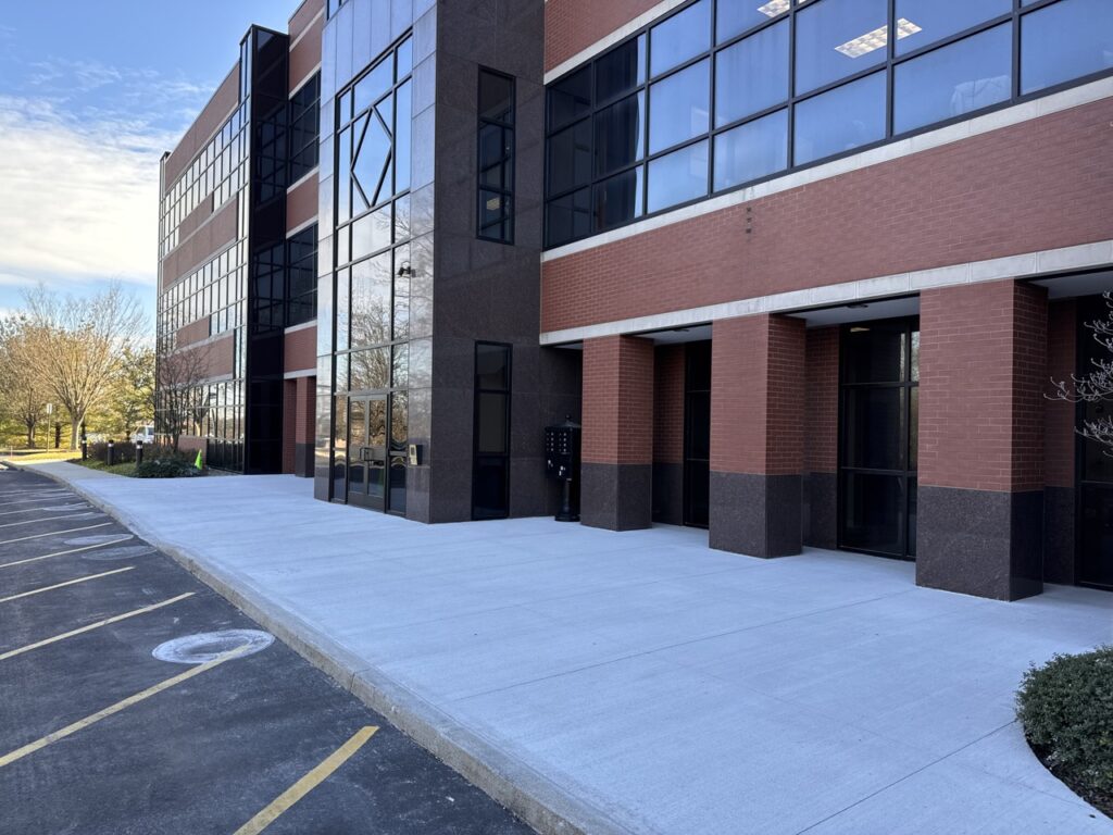 Newly replaced concrete walkway leading to the modern office building in Allentown, PA enhances the entrance appeal.