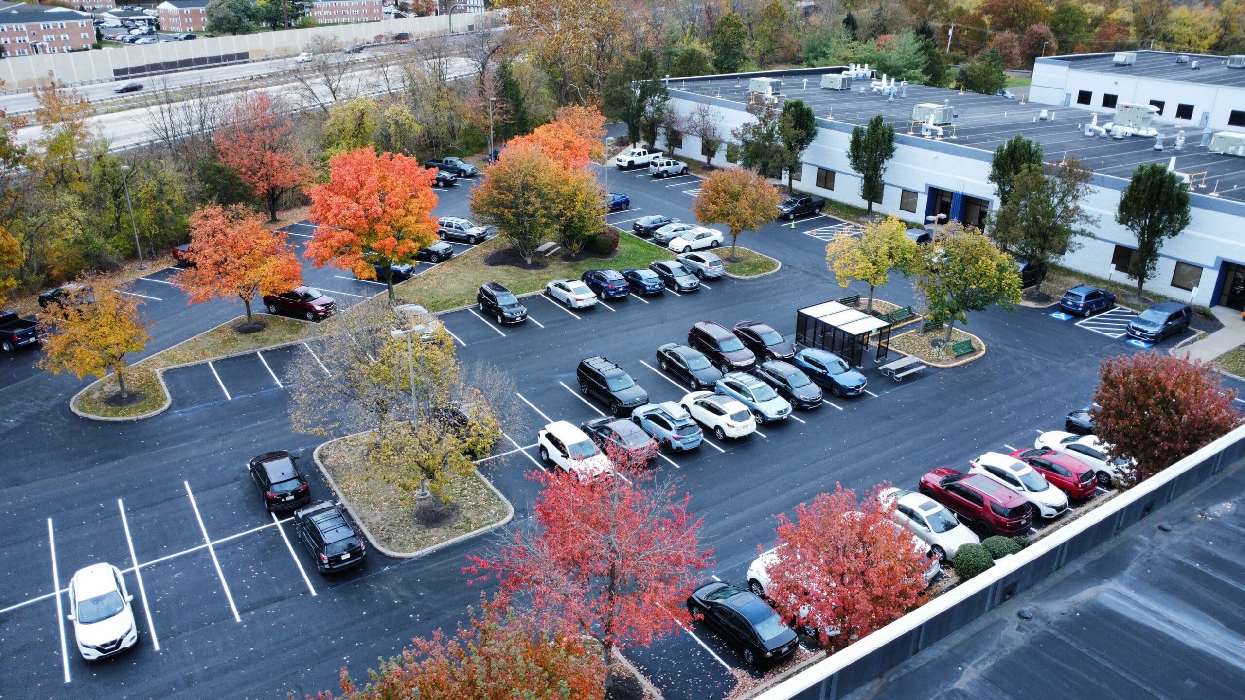 Swan Co asphalt resurfacing around a Bristol, PA commercial warehouse with new pavement and safety markings.