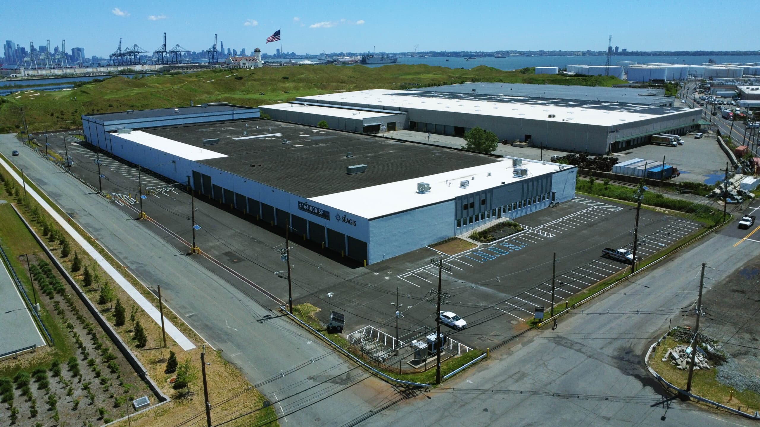 Aerial view of Swan Co. asphalt paving and line striping at an industrial property in Bayonne, NJ with parking areas and loading zones.