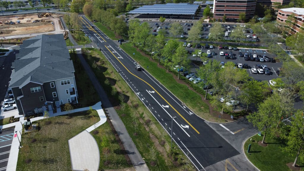 Aerial view of roadway paving and fresh line striping at BXP Carnegie Center, with parking lots and office buildings nearby.